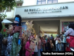 Ratusan siswa kirab budaya bertema wayang di SD Negeri 26 Solo dalam kegiatan Wayang Masuk Sekolah, Rabu (18/7).
