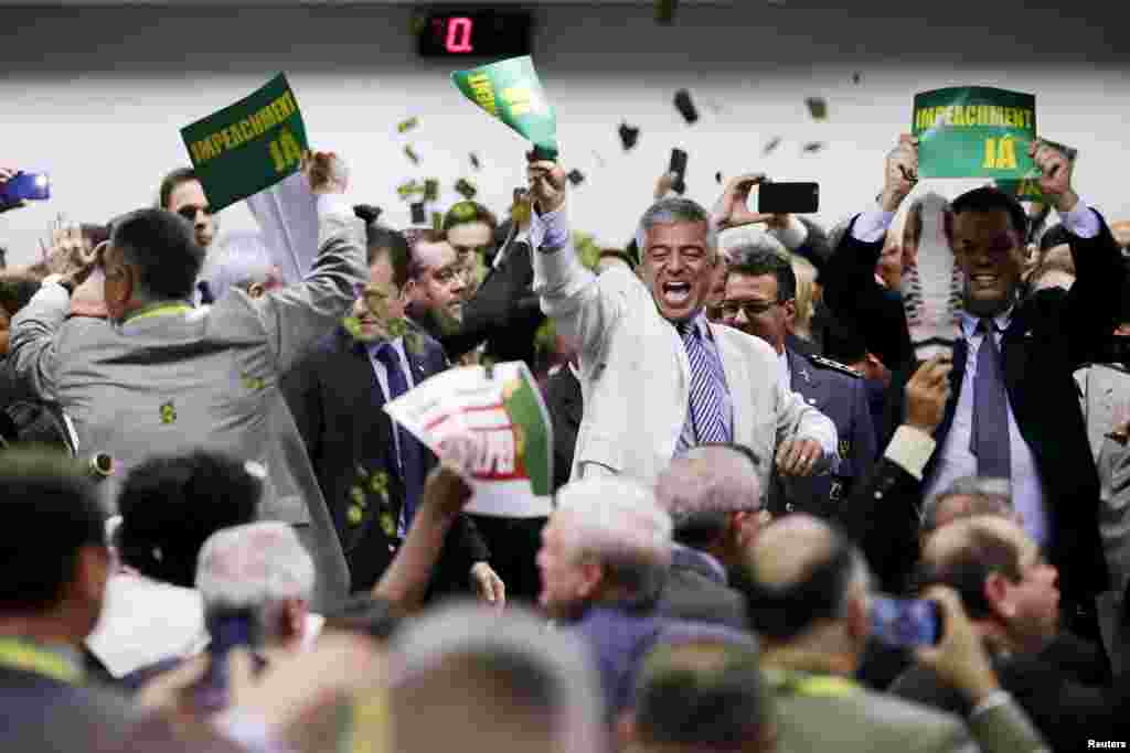 Members of the impeachment committee celebrate after voting on the impeachment of Brazilian President Dilma Rousseff at the National Congress in Brasilia, Brazil, April 11, 2016.
