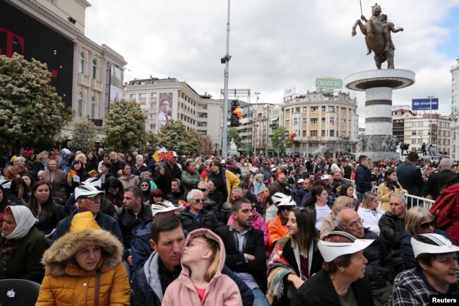 People wait for Pope Francis to arrive and lead the Holy Mass at the Macedonia square in Skopje, North Macedonia, May 7, 2019.