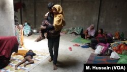 A sick Rohingya refugee is carried from one room to another in a Rohingya refugee camp in West Bengal, eastern India in April 2018. After receiving threats from the Hindu nationalists group in north India, where the Rohingya lived for years since fleeing 