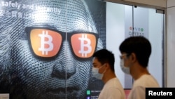 An advertisement for Bitcoin and cryptocurrencies is seen in Hong Kong, Sept. 27, 2021. 