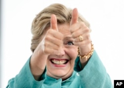 Democratic presidential candidate Hillary Clinton gives two thumbs up as she takes the stage to speak at a rally at C.B. Smith Park in Pembroke Pines, Fla., Nov. 5, 2016.