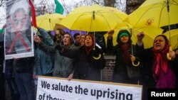 Opponents of Iranian President Hassan Rouhani hold a protest outside the Iranian embassy in west London, Dec. 31, 2017.