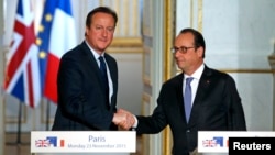 French President Francois Hollande (R) shakes hands with Britain's Prime Minister David Cameron during a joint news conference Nov. 23, 2015, at the Elysee Palace in Paris.