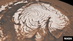 This image from two instruments aboard NASA’s Mars Global Surveyor, depicts an orbital view of the north polar region of Mars. New findings from the Mars Reconnaissance Orbiter have revealed subsurface geology in this region.