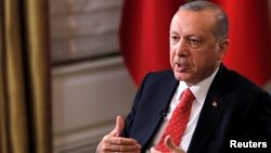 FILE - Turkish President Recep Tayyip Erdogan sits during an interview in Manhattan, New York, Sept. 25, 2018.