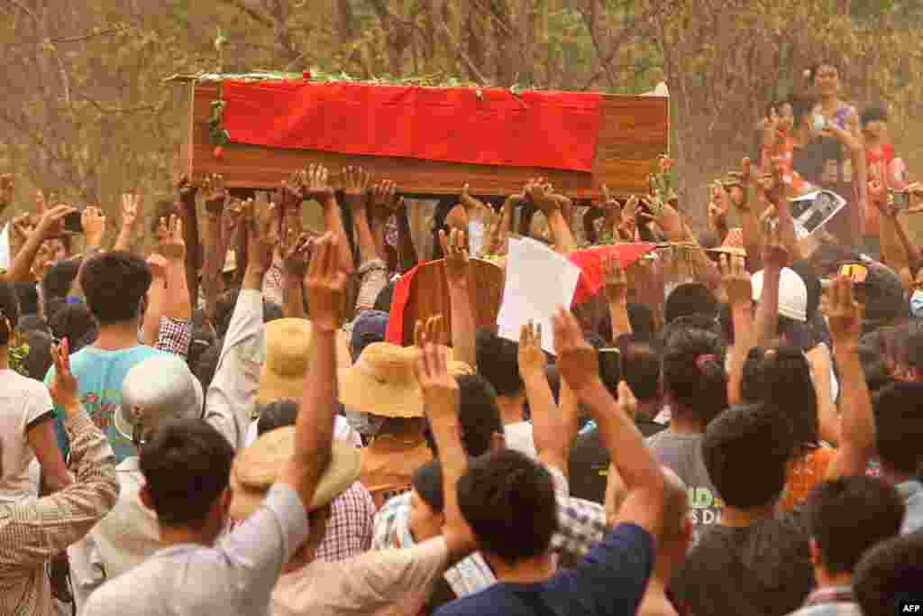 This photo received via Facebook shows mourners making the three-finger salute during funerals of three protesters, who were shot dead the day before during a crackdown by security forces on anti-coup demonstrations in Monywa, Sagaing region, Myanmar.