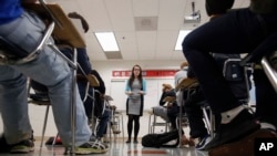 In this photo taken Jan. 17, 2016, Katerina Maylock, with Capital Educators, teaches a college test preparation class at Holton Arms School in Bethesda, Maryland. (AP Photo/Alex Brandon)