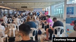  Passengers arrive and wait to be screened at Phuket International Airport (Photo by GABRIEL PIERCE)