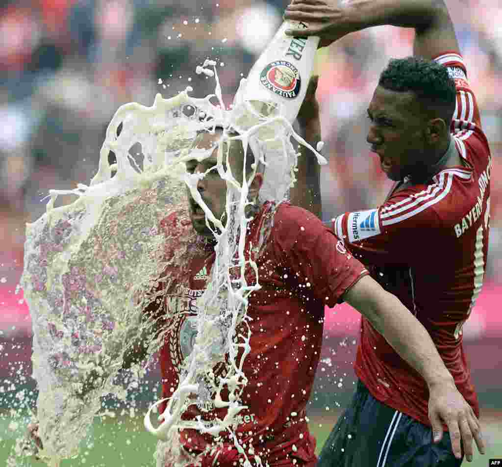 Bayern Munich&#39;s defender Jerome Boateng (R) pours beer on Bayern Munich&#39;s French midfielder Franck Ribery while celebrating their champion title, after winning 3:0 the German first division Bundesliga football match between Bayern Munich and FC Augsburg in Munich, southern Germany, May 11, 2013.
