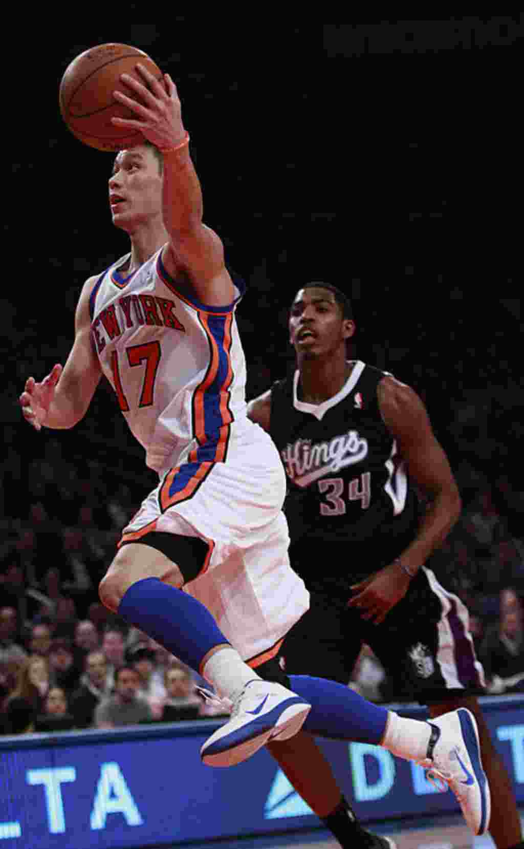 New York Knicks' Jeremy Lin drives past Sacramento Kings' Jason Thompson during the first half of an NBA basketball game on February 15, 2012, in New York. (AP)