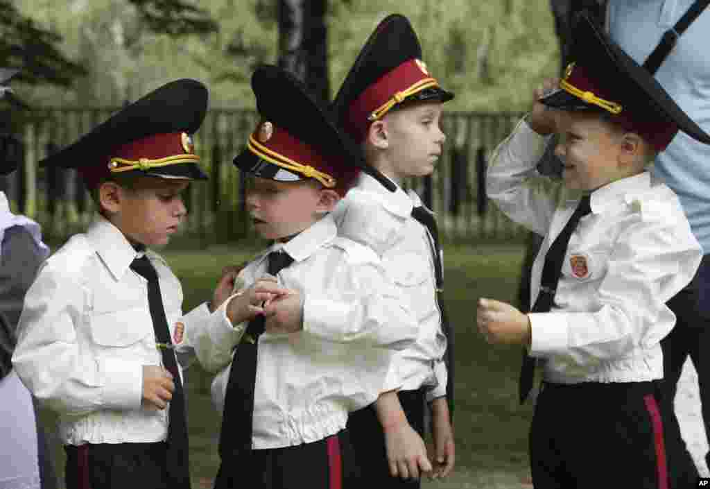 Young cadets examine their uniforms prior to a ceremony on the occasion of the first day of school at a cadet lyceum in Kyiv, Ukraine.