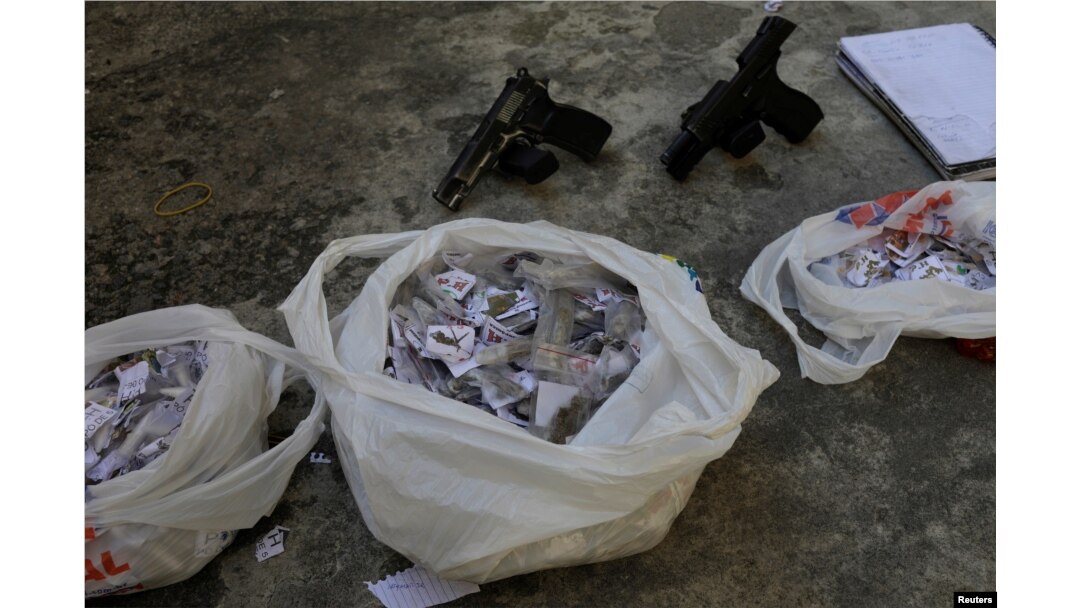 Drugs and guns seized from suspects arrested during violent clashes with Brazilian Army soldiers in Rio de Janeiro, Brazil, Aug. 20, 2018.