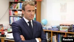 French President Emmanuel Macron looks on as he meets with the pupils of the localized educational inclusion units class at the Jules Renard secondary school in Laval, France, Sept. 3, 2018.
