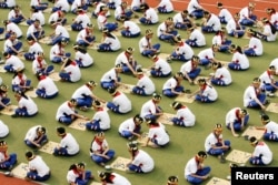 FILE - Students play the board game Go during a competition to mark the 100-day countdown to the opening of the Beijing Olympics at a primary school in Suzhou, Jiangsu province, April 30, 2008.