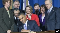 FILE - Lawmakers and supporters look on as President Barack Obama signs legislation to repeal the "Don't Ask, Don't Tell" policy and allow gays to serve openly in the military in Washington, Dec. 22, 2010.
