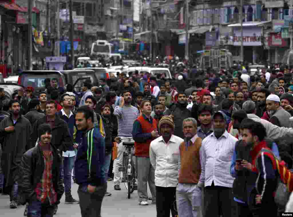 People rush into the streets, vacating buildings following a powerful earthquake in Srinagar, Kashmir, Oct. 26, 2015.