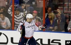 Fans celebrate with Washington Capital's Alex Overchkin after he scored a goal during the second period of an NHL hockey game against the Florida Panthers in Sunrise, Fla., April 6, 2013.