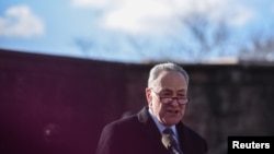 U.S. Senator Chuck Schumer addresses the crowd during a protest against President Donald Trump