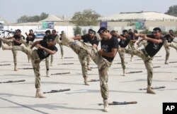 FILE - Commandos of Pakistan's Coast Guards demonstrate their skills during a ceremony in Karachi, Pakistan, Feb. 22, 2018. They are specially trained for counterterror operations.
