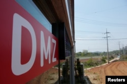 A sign advertising properties within and along the demilitarized zone (DMZ) that separates the two Koreas, is seen at a real estate agency in Munsan, South Korea, May 10, 2018.
