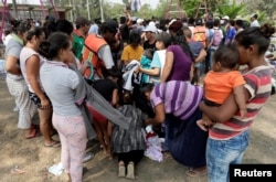 Central American migrants receive donated clothes on their journey to the U.S., in Matias Romero, Oaxaca, Mexico, April 3, 2018.