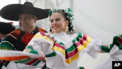 FILE - Members of a ballet folklorico perform outside AT&T stadium as part of the Hispanic Heritage Month celebration before an NFL football game.