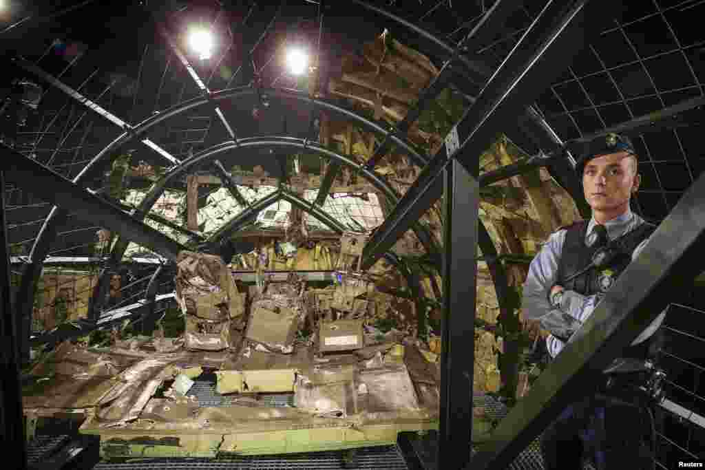 A military policeman stands guard in the cockpit of the MH17 airplane after the presentation of the final report into the crash of July 2014 of Malaysia Airlines flight MH17 over Ukraine in Gilze Rijen, the Netherlands, October 13, 2015.