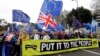 Demonstrators hold a banner during a Peoples Vote anti-Brexit march in London, March 23, 2019.