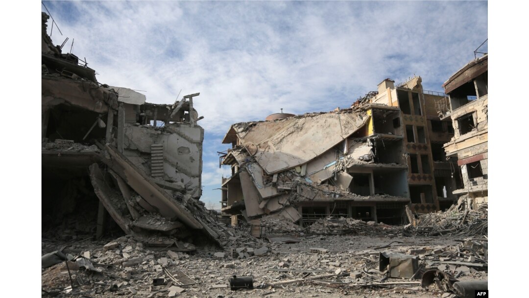 Buildings destroyed during various Syrian government bombardments are seen in the rebel-held town of Hamouria in the Eastern Ghouta region on the outskirts of Damascus, March 13, 2018.