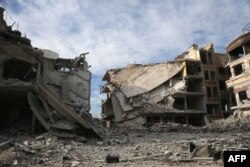 Buildings destroyed during various Syrian government bombardments are seen in the rebel-held town of Hamouria in the Eastern Ghouta region on the outskirts of Damascus, March 13, 2018.