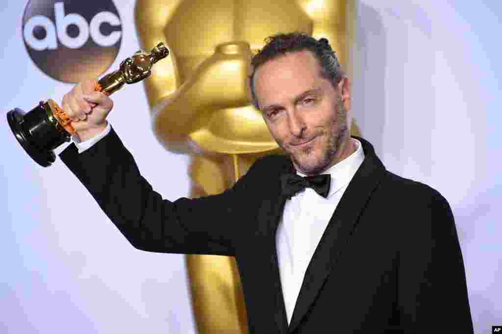 Emmanuel Lubezki poses with the award for best cinematography for “The Revenant” in the press room at the Oscars on Feb. 28, 2016, at the Dolby Theatre in Los Angeles.