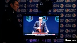 A television screen shows Democratic Party leader Pierluigi Bersani at a media center in Rome, February 26, 2013. 