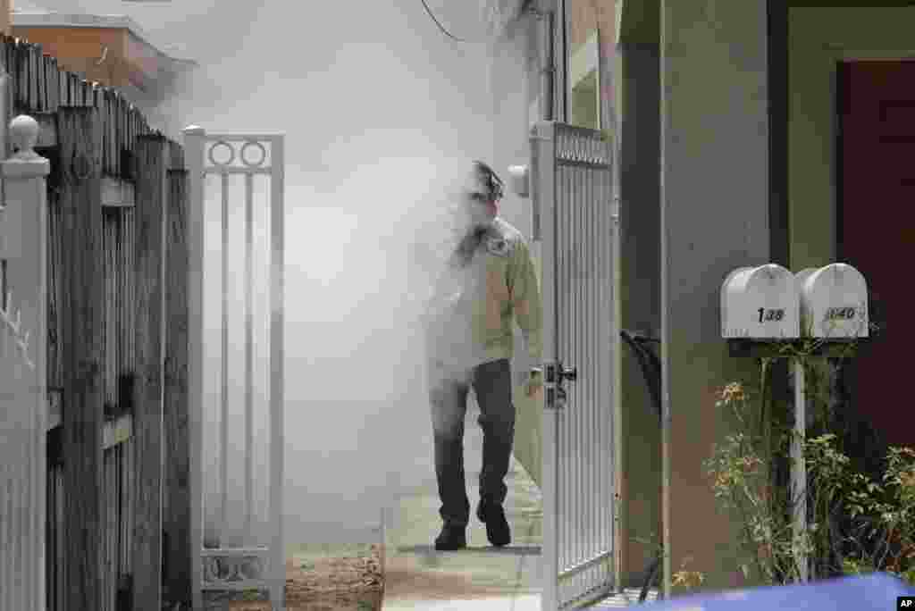 A Miami-Dade County mosquito control worker sprays around a home in the Wynwood area of Miami, Florida.&nbsp;The Center for Disease Control and Prevention has issued a new advisory that says pregnant women should not travel a Zika-stricken part of Miami.