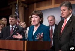 FILE - Senator Susan Collins, R-Maine, is joined by other members of her "commonsense coalition" to discuss immigration during a news conference at the Capitol in Washington, Feb. 15, 2018.