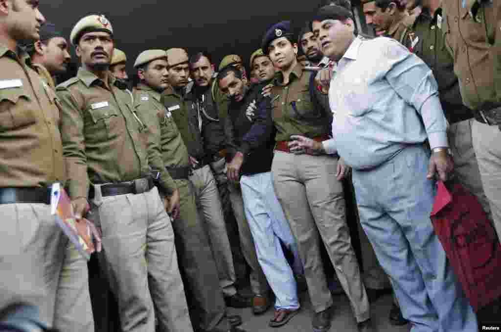 Policemen escort driver Shiv Kumar Yadav, who is accused of a rape, outside a court in New Delhi, Dec. 8, 2014.