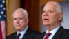 FILE - Sen. Ben Cardin, right, holds a news conference with Sen. John McCain during a media availability on Capitol Hill in Washington, Dec. 6, 2012. 