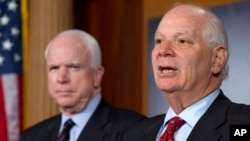 FILE - Sen. Ben Cardin, right, holds a news conference with Sen. John McCain during a media availability on Capitol Hill in Washington, Dec. 6, 2012. 