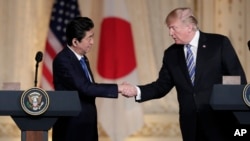 Japanese Prime Minister Shinzo Abe, left, and President Donald Trump shake hands during a news conference at Trump's private Mar-a-Lago club, April 18, 2018, in Palm Beach, Florida.