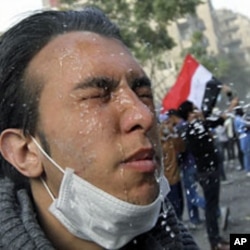An injured protester receives treatment during clashes with riot police along a road leading to the Interior Ministry, near Tahrir Square in Cairo, November 23, 2011