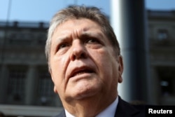 FILE - Former Peruvian president Alan Garcia talks to the media as he arrives at the National Prosecution office in Lima, Peru, March 27, 2018.