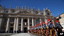 Guardias suizos marchan frente a la Basílica de San Pedro, en El Vaticano. Diciembre 25 de 2018.