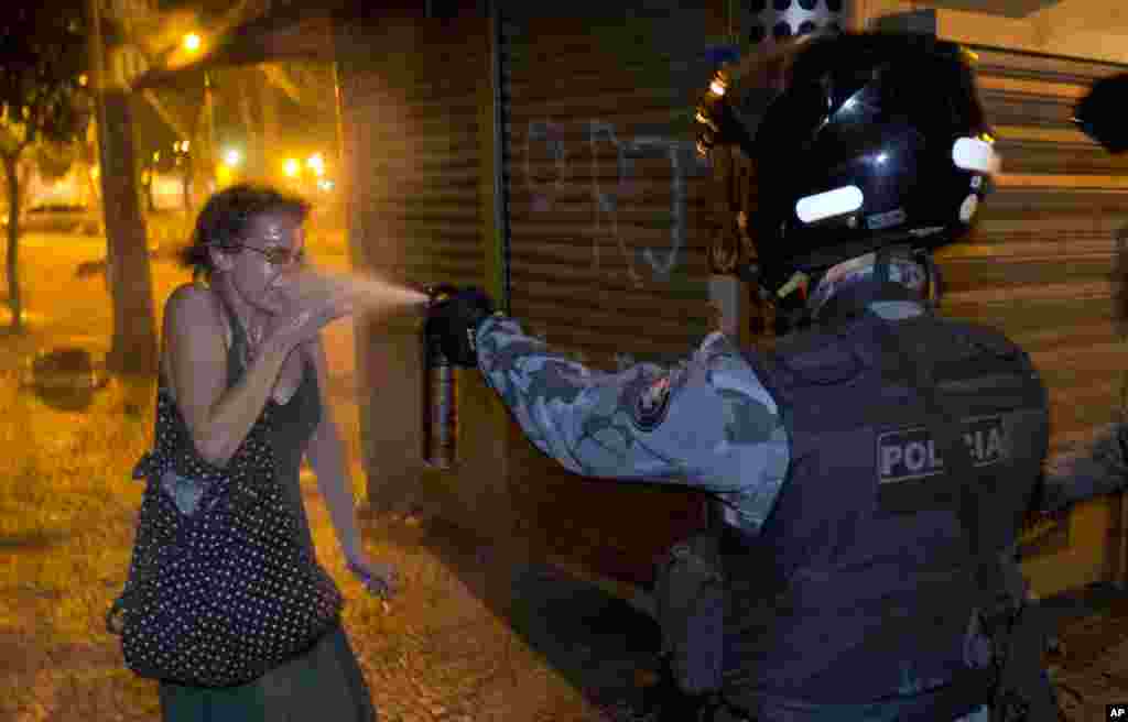 A military police peper sprays a protester during a demonstration in Rio de Janeiro, Brazil, June 17, 2013. Protesters massed in at least seven Brazilian cities for another round of demonstrations voicing disgruntlement about life in the country, raising questions about security during big events like the current Confederations Cup and a papal visit next month.