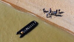 A group of people thought to be migrants are escorted to shore in Kingsdown, after being intercepted by an RNLI crew following a small boat incident in the Channel, in Kent, England, Sept. 7, 2021.