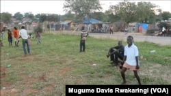 A young South Sudanese boy celebrates after scoring a goal on a ramshackle football pitch near Juba.