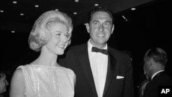 FILE - Doris Day, a best actress of the year nominee for her role in "Pillow Talk," and her producer husband Marty Melcher, arrive for the annual Academy Award Oscar presentations at the Pantages Theater in Los Angeles, April 4, 1960.