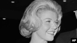 FILE - Doris Day, a best actress of the year nominee for her role in "Pillow Talk," and her producer husband Marty Melcher, arrive for the annual Academy Award Oscar presentations at the Pantages Theater in Los Angeles, April 4, 1960.