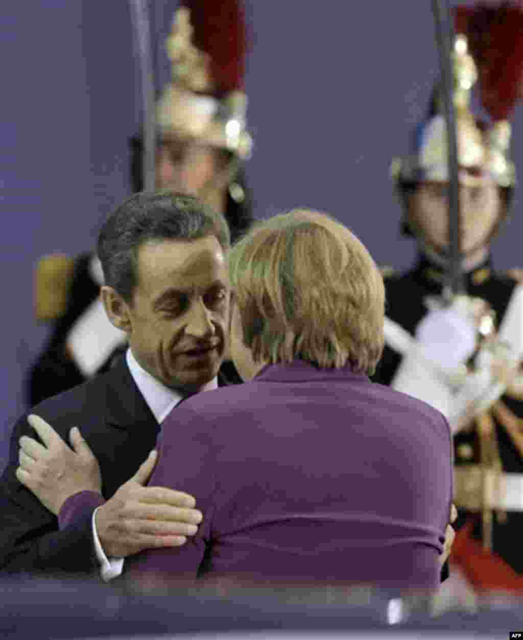 French President Nicolas Sarkozy, left, greets German Chancellor Angela Merkel during arrivals for the G20 summit in Cannes, France on Wednesday, Nov. 2, 2011. Greek Prime Minister George Papandreou was flying to the chic French Riviera resort of Cannes