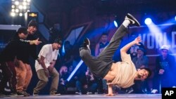 The Floorriorz from Japan in action against Russia's Kienjuice during the SNIPES Battle of the Year breakdancing final at the Grugahalle in Essen, Germany on October 21, 2017 (Little Shao/Red Bull Content Pool via AP Images)