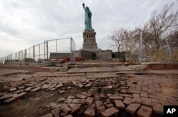 During a media tour parts of a brick walkway on New York’s Liberty Island, damaged in Superstorm Sandy, are seen, Nov. 30, 2012